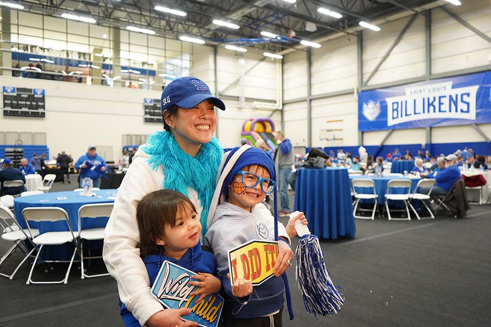 A family takes a photo at a photobooth during Alumni Fan Fest.