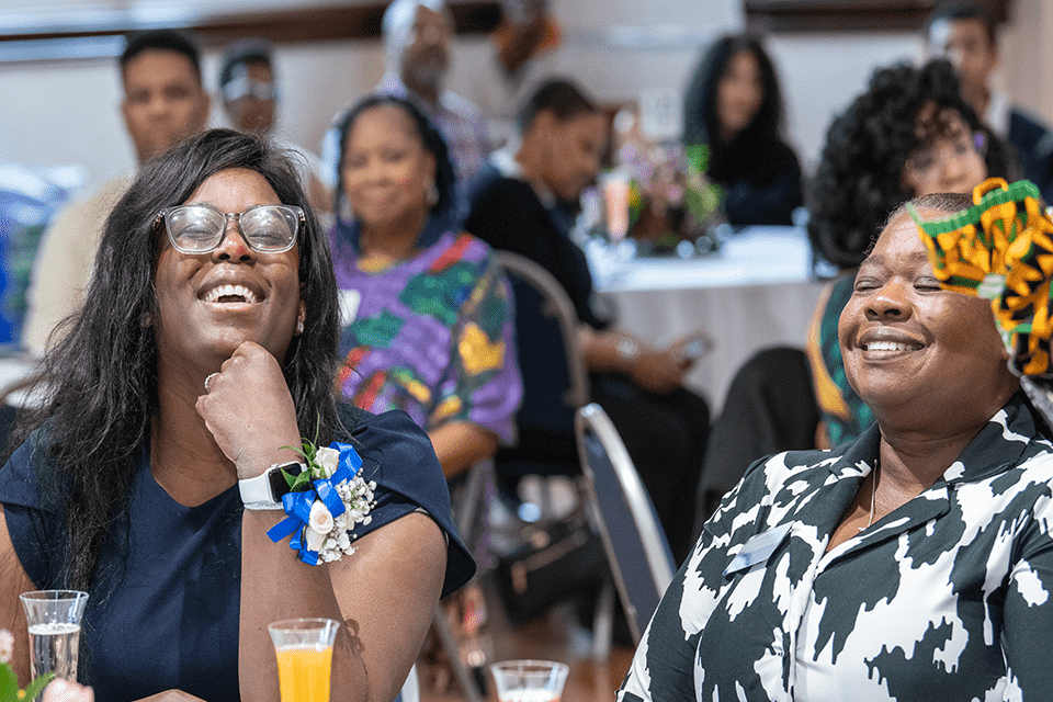 Ornella (Nelly) Balley, BAA president,  and LaVerne Robinson listen to speakers at Saint Louis University's Black Alumni Association Prayer Breakfast 2024.