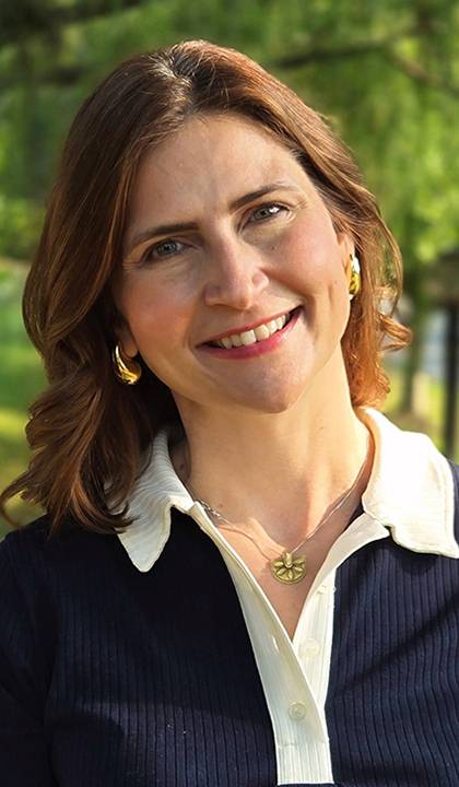 Headshot of Ashley Milam standing outside in front of a tree