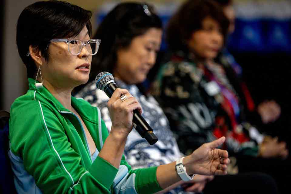 Elaine Cha, a woman with short dark hair and glasses, speaks on the Asian Women in Leadership Panel at the Be Heard Women in Leadership Conference.