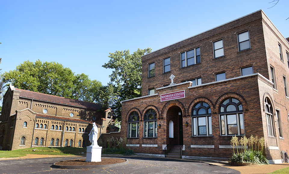 Manresa Center, a brick building with arches above the windows and an arched doorway.