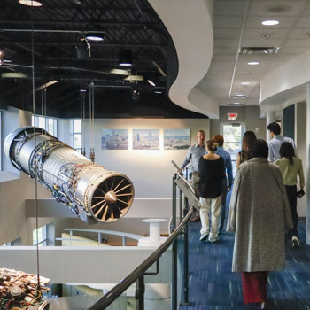 Students at GE Aerospace looking at engine displays.