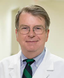 A headshot of Richard Bucholz, M.D., in a white jacket. Richard Bucholz, M.D.